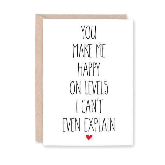 Greeting card with orange text that says "you make me happy on levels I can't even explain"