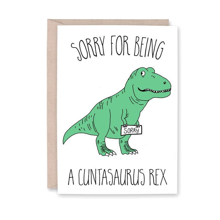 greeting card with an illustration of a green T-rex dinosaur holding a sign that says Sorry.
