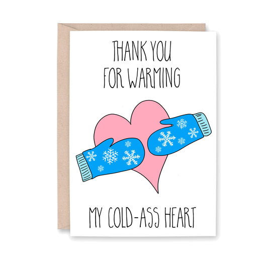 Greeting card that reads "Thank yo ufor warming my cold-ass heart" with an illustration of a pink heart with blue winter gloves with snowflakes on them.