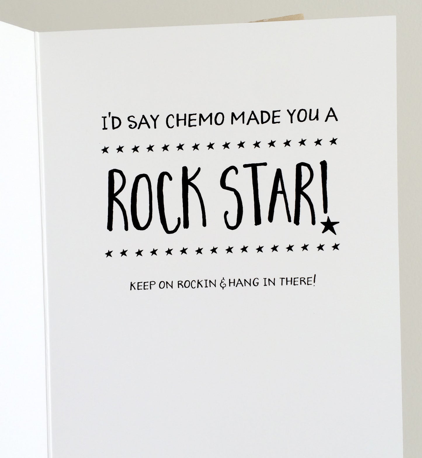 Inside of the greeting card that says "I'd say chemo made you a ROCK STAR! Keep on rockin & hang in there"