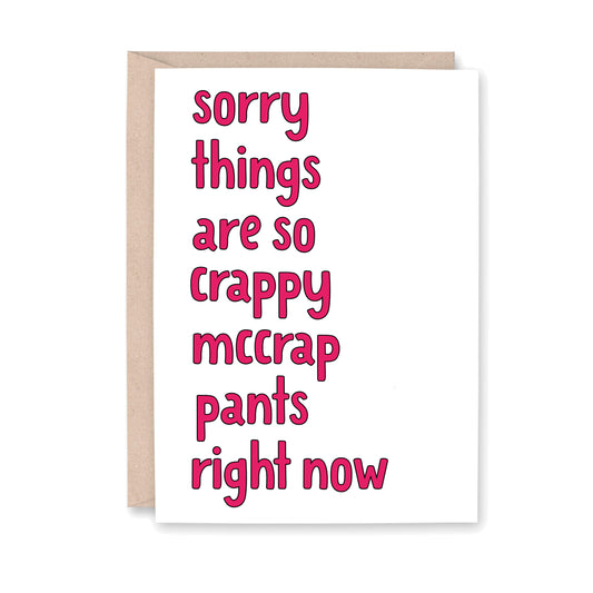 Greeting card with dark pink text that reads "sorry things are so crappy mccrap pants right now"